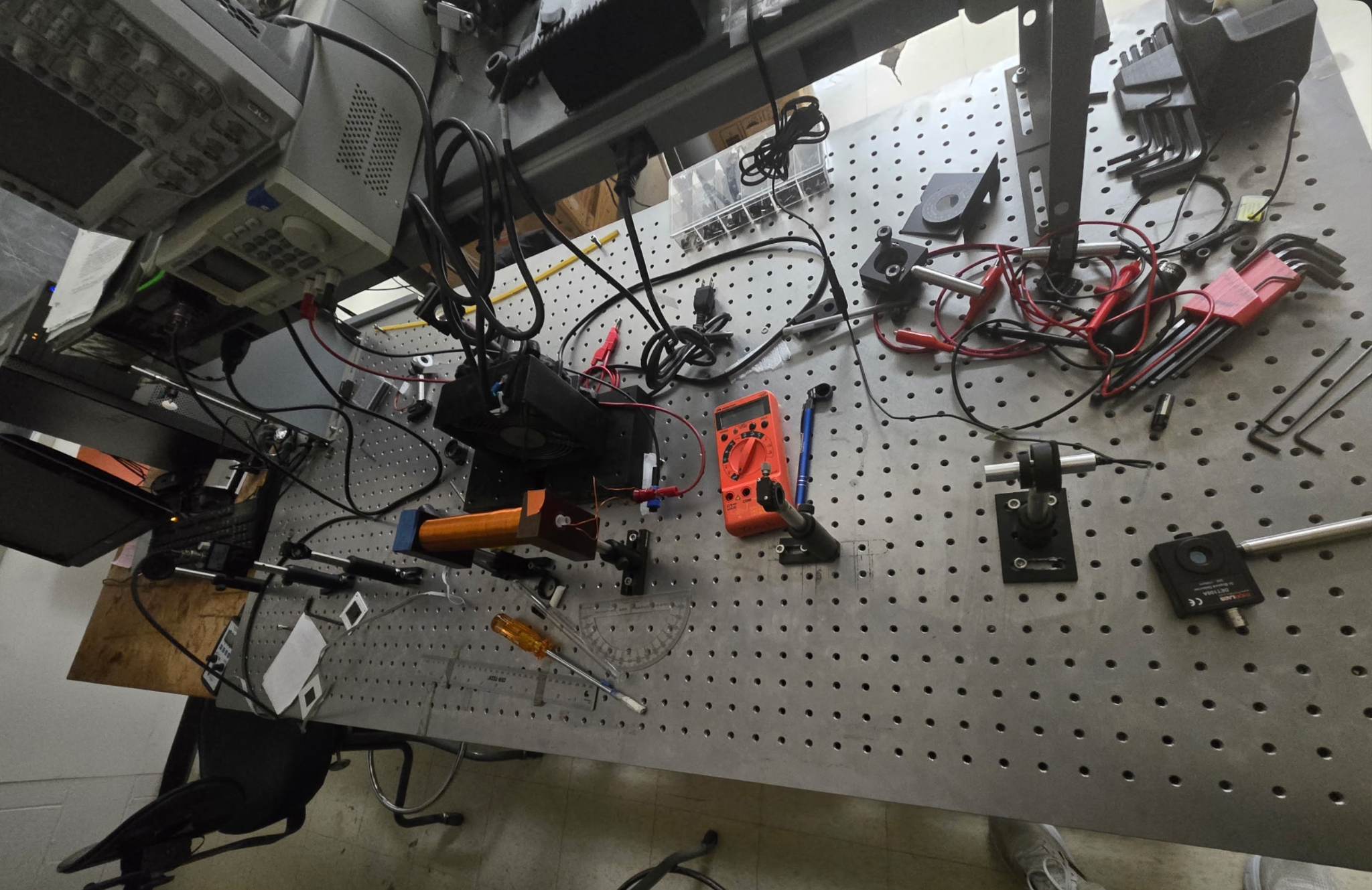 Optical bench, coils, polarizers, and measurement equipment used for the Faraday-rotation experiment.